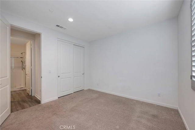 unfurnished bedroom with carpet flooring and a closet