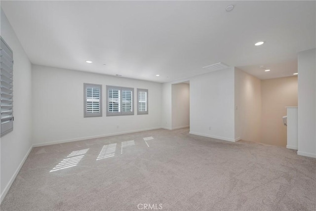 unfurnished room featuring light colored carpet