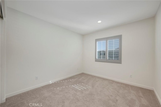 empty room featuring light carpet