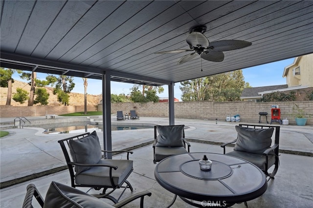 view of patio with a fenced in pool and ceiling fan