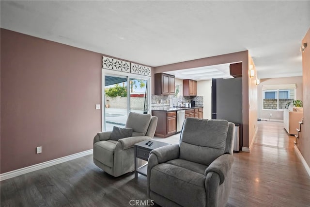 living room featuring sink and dark hardwood / wood-style flooring