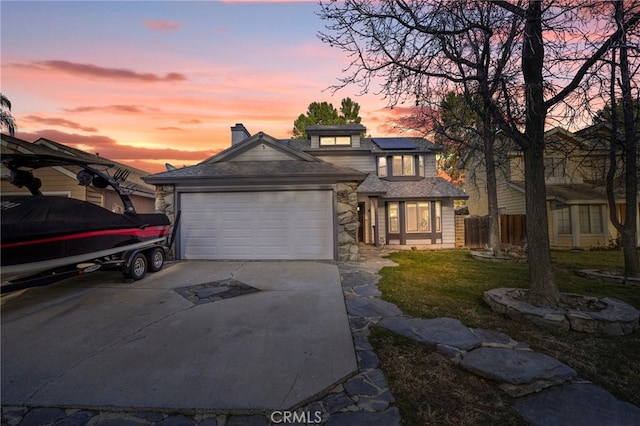 view of front of home with a garage and solar panels