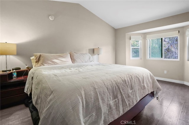 bedroom featuring lofted ceiling and dark wood-type flooring