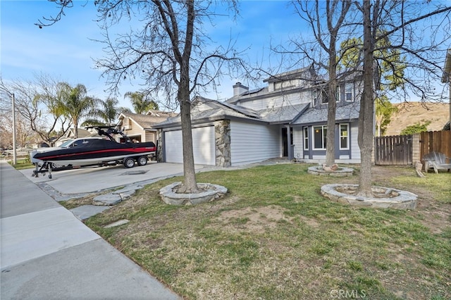 view of front of home with a garage and a front lawn