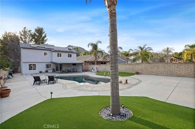 view of swimming pool featuring a lawn and a patio