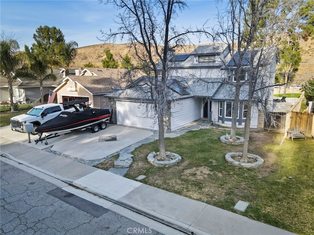 view of front of house with a garage and a front lawn