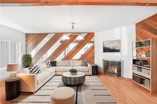 living room featuring a fireplace, light hardwood / wood-style floors, and a textured ceiling