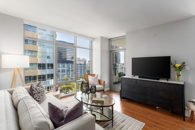 living room featuring hardwood / wood-style flooring and a wall of windows