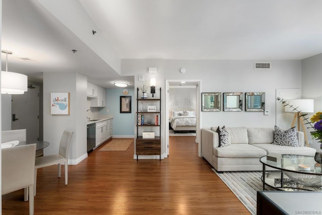 living room with sink and dark hardwood / wood-style flooring