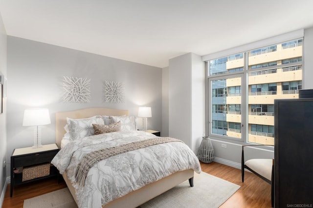 bedroom featuring hardwood / wood-style flooring and multiple windows