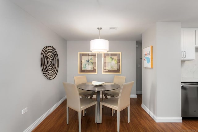 dining room with dark wood-type flooring