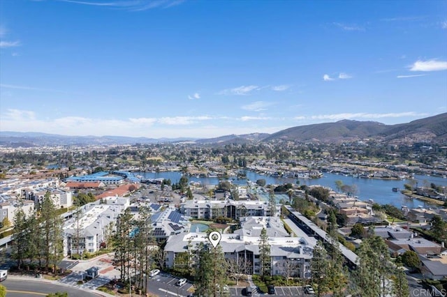 drone / aerial view featuring a water and mountain view