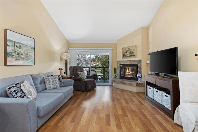 living room with hardwood / wood-style flooring and a high end fireplace