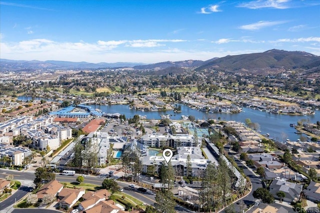 drone / aerial view featuring a water and mountain view