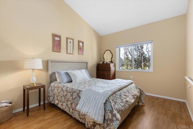 bedroom with hardwood / wood-style floors and vaulted ceiling