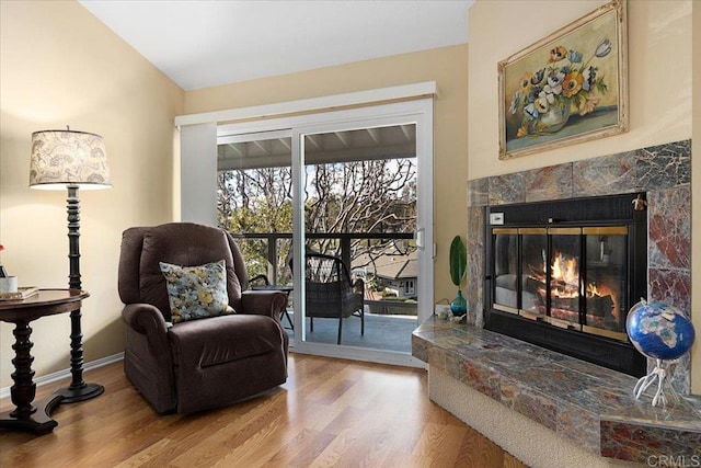 sitting room featuring a fireplace and light wood-type flooring