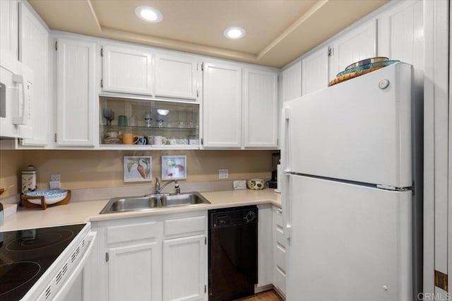 kitchen with sink, white cabinets, and white appliances