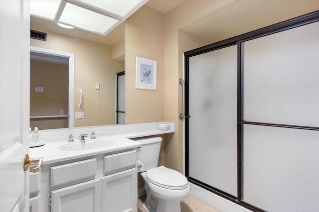 bathroom featuring vanity, toilet, and an enclosed shower