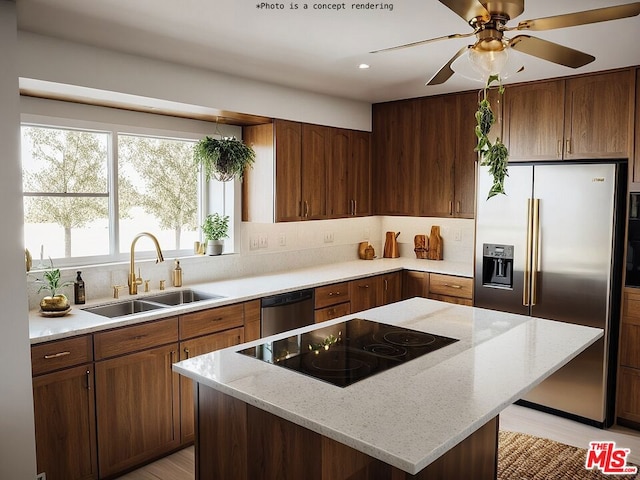 kitchen with sink, appliances with stainless steel finishes, light stone counters, a kitchen island, and decorative backsplash