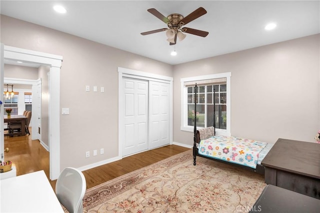 bedroom featuring wood-type flooring, a closet, and ceiling fan