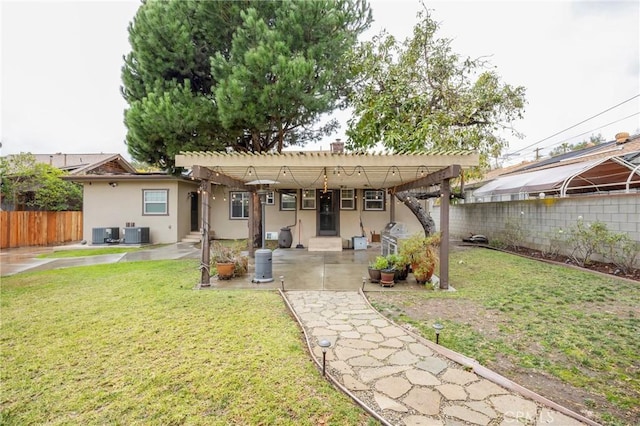 back of house featuring a patio, a lawn, and central air condition unit