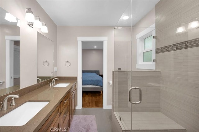 bathroom with tile patterned floors, vanity, and a shower with door