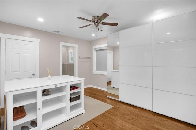 interior space with hardwood / wood-style floors and ceiling fan