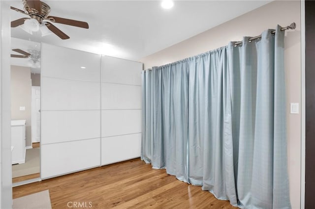 interior space featuring light hardwood / wood-style flooring and ceiling fan