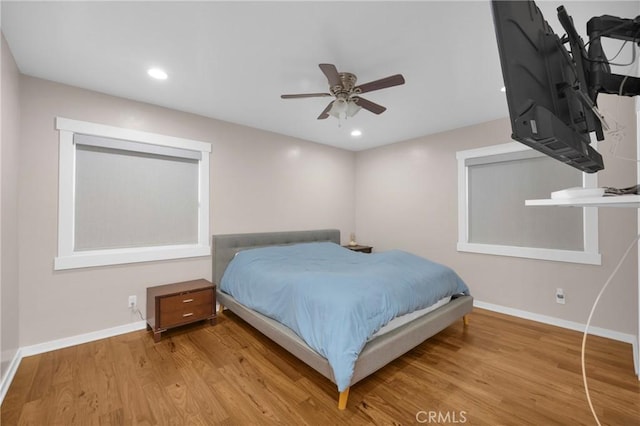 bedroom with ceiling fan and light hardwood / wood-style flooring