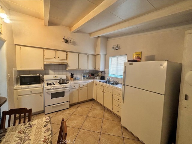 kitchen with beam ceiling, sink, white appliances, and decorative backsplash