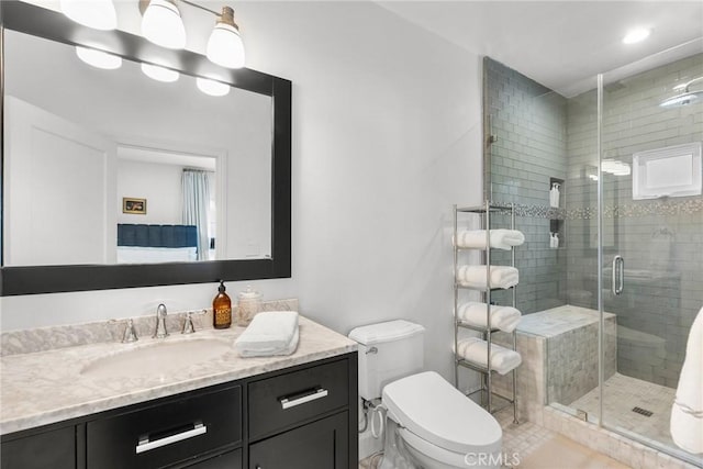 bathroom with an enclosed shower, vanity, and toilet