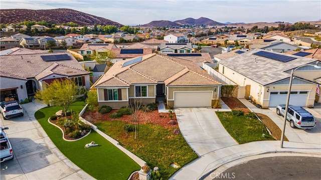 exterior space with a garage and a mountain view