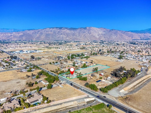 birds eye view of property with a mountain view