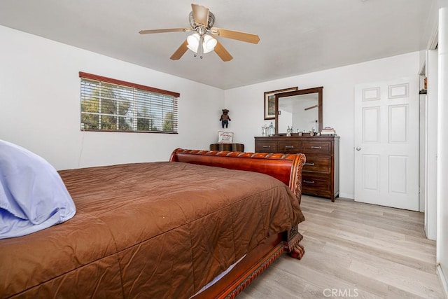 bedroom with ceiling fan and light hardwood / wood-style floors