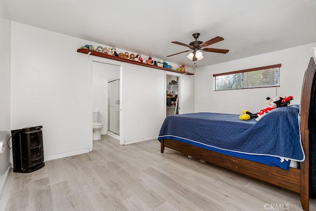 bedroom featuring connected bathroom, ceiling fan, and light wood-type flooring