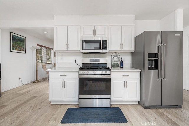 kitchen featuring light hardwood / wood-style floors, white cabinets, and appliances with stainless steel finishes