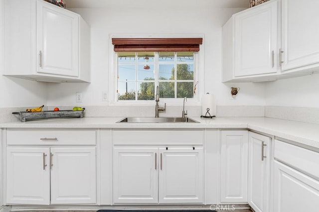 kitchen featuring sink and white cabinets