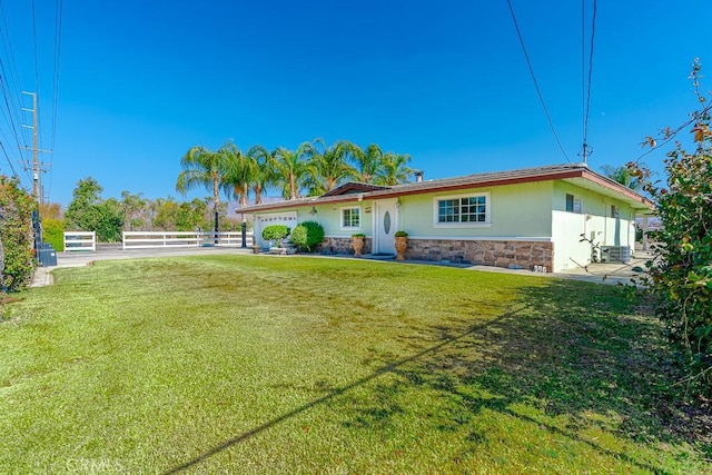 view of front of property with a garage and a front lawn