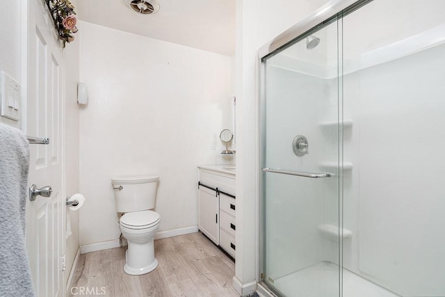 bathroom featuring an enclosed shower, hardwood / wood-style floors, vanity, and toilet