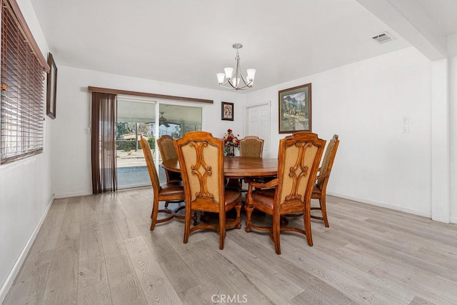 dining area featuring a notable chandelier and light wood-type flooring