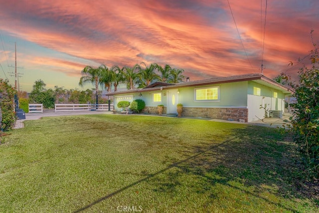 view of front of property with a yard and a garage