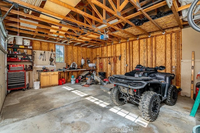 garage featuring a garage door opener and a workshop area