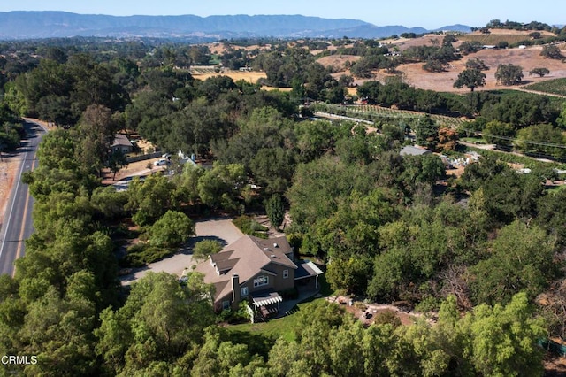 birds eye view of property featuring a forest view