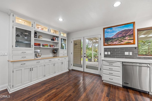 kitchen with dark wood-style flooring, open shelves, light countertops, glass insert cabinets, and dishwasher