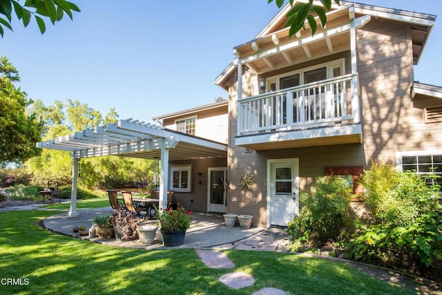 back of property with a lawn, a patio area, a balcony, and a pergola