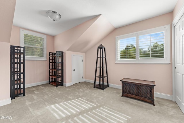 additional living space with carpet floors, vaulted ceiling, and baseboards