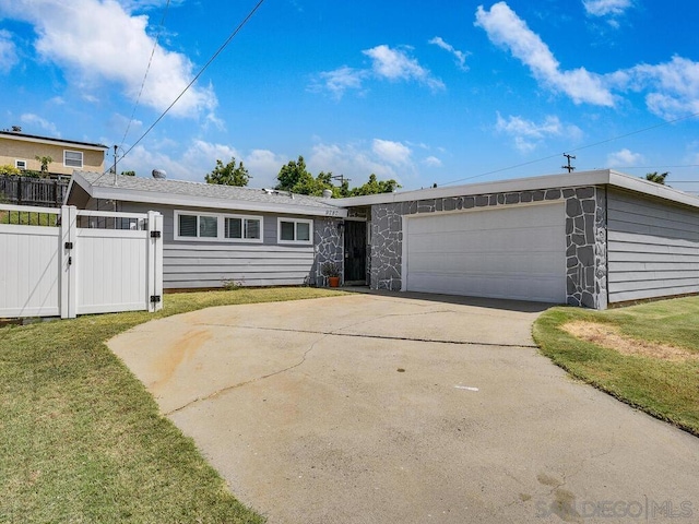 single story home featuring a garage and a front yard