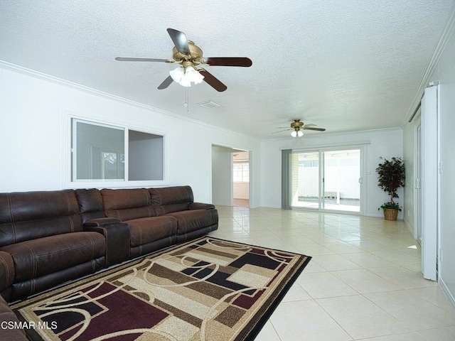 living room featuring light tile patterned flooring, a textured ceiling, and crown molding