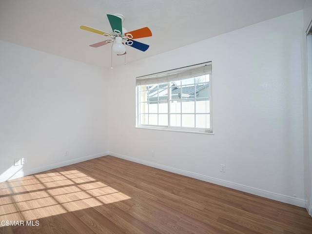 unfurnished room with hardwood / wood-style flooring and ceiling fan