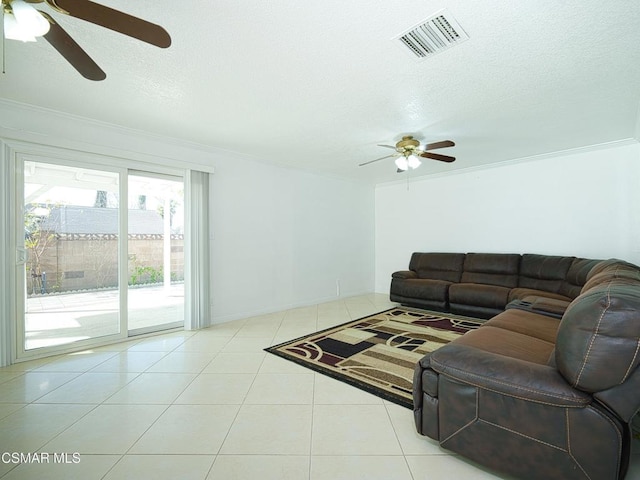 tiled living room with crown molding, ceiling fan, and a textured ceiling